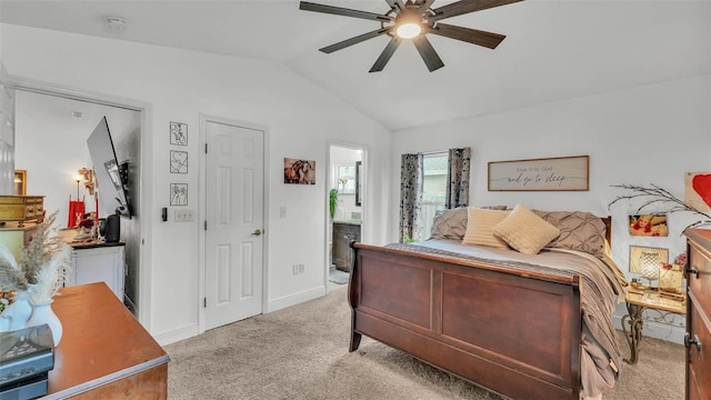 242 Kings Pond Ave SW, Winter Haven, FL 33880 - bedroom featuring vaulted ceiling, light carpet, baseboards, ensuite bath, and ceiling fan