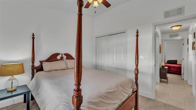 242 Kings Pond Ave SW, Winter Haven, FL 33880 - bedroom featuring a closet, baseboards, ceiling fan, light tile patterned floors, and light colored carpet