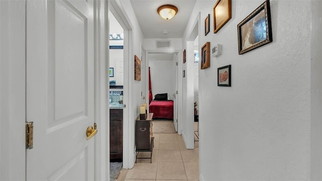 242 Kings Pond Ave SW, Winter Haven, FL 33880 - hall with light tile patterned flooring, baseboards, and a textured wall