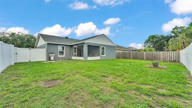 242 Kings Pond Ave SW, Winter Haven, FL 33880 - back of house with stucco siding, a gate, and a sunroom