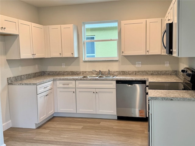 629 W 9th, Lakeland, FL 33805 - kitchen with stainless steel dishwasher, a sink, black microwave, and white cabinets