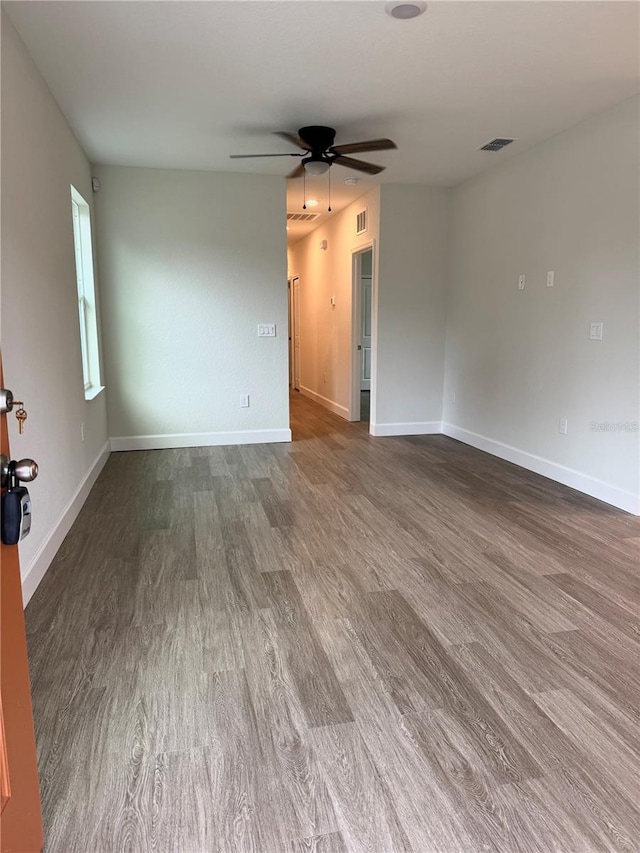 629 W 9th, Lakeland, FL 33805 - empty room with a ceiling fan, wood finished floors, and baseboards