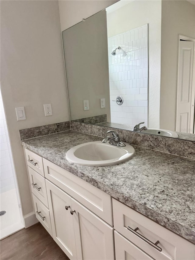 629 W 9th, Lakeland, FL 33805 - bathroom with a shower stall, vanity, and wood finished floors
