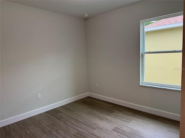 629 W 9th, Lakeland, FL 33805 - spare room featuring dark wood-style flooring, baseboards, and a smoke detector