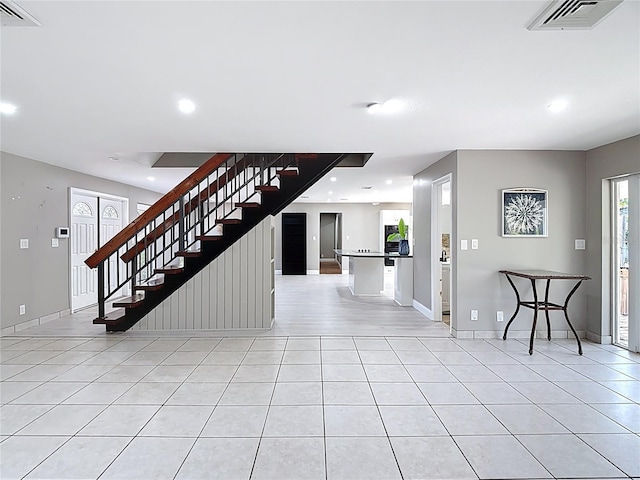 foyer entrance featuring light tile patterned floors, visible vents, stairway, and recessed lighting