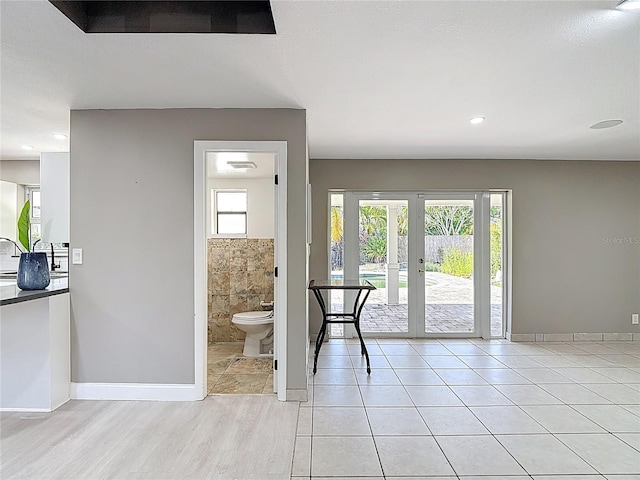 foyer entrance with a wealth of natural light, french doors, baseboards, and recessed lighting