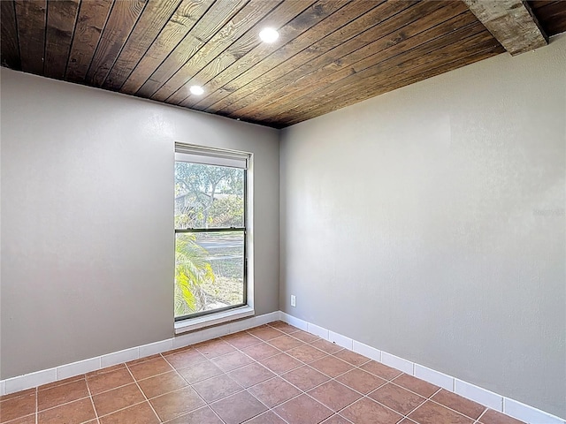 tiled spare room featuring wooden ceiling, baseboards, and recessed lighting