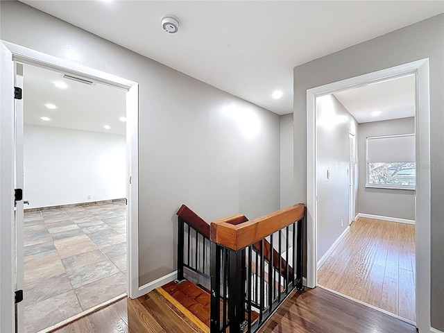 stairs with recessed lighting, baseboards, visible vents, and wood finished floors