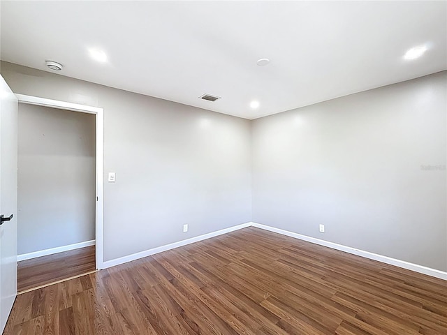 unfurnished room with baseboards, recessed lighting, visible vents, and wood finished floors
