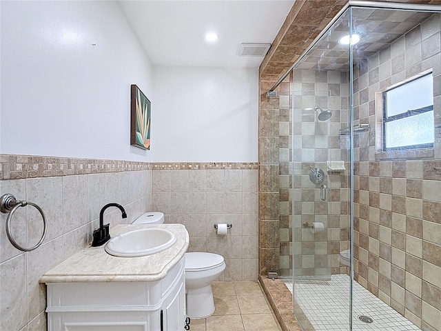 full bath featuring a stall shower, tile patterned flooring, and tile walls