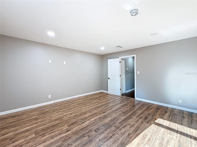 spare room featuring recessed lighting, baseboards, visible vents, and wood finished floors