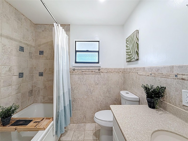 full bath featuring tile walls, toilet, shower / tub combo with curtain, tile patterned floors, and vanity