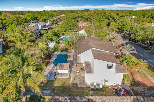 birds eye view of property with a view of trees