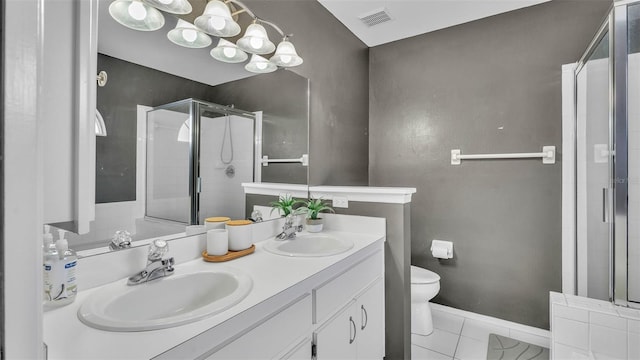 bathroom featuring a shower stall, tile patterned flooring, toilet, and double vanity