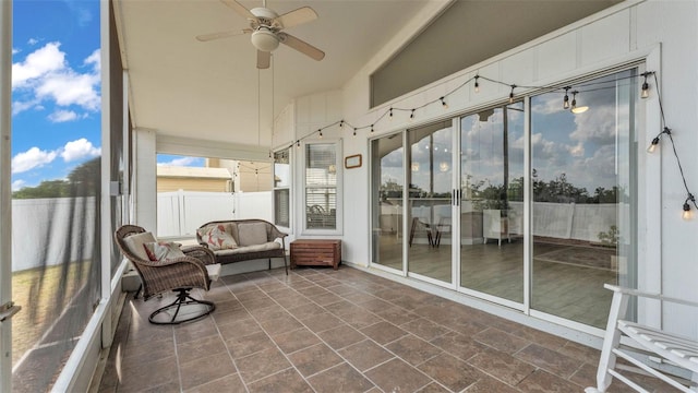 sunroom with a ceiling fan, lofted ceiling, and an outdoor hangout area