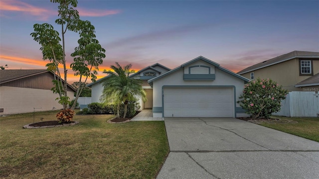 ranch-style house with driveway, a garage, and stucco siding