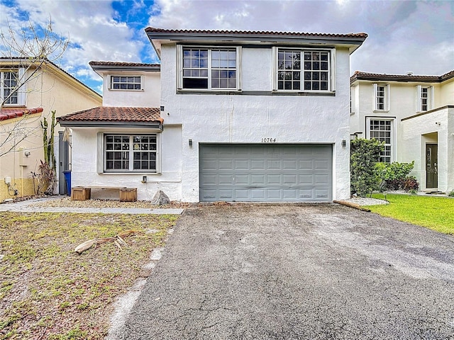10764 Lenox Rd, Hollywood, FL 33026 - view of front of house featuring driveway, stucco siding, a garage, and a tile roof