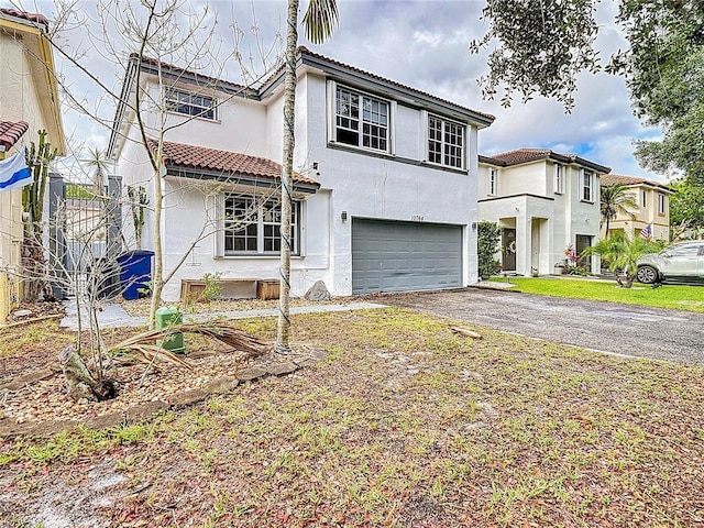 10764 Lenox Rd, Hollywood, FL 33026 - view of front of home with a garage, stucco siding, asphalt driveway, and a tile roof