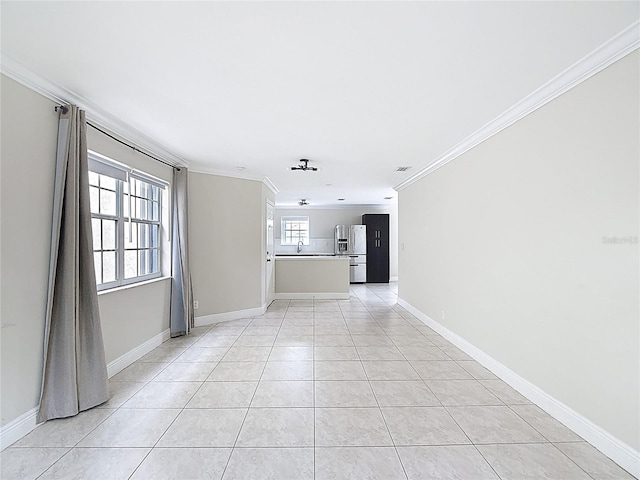 10764 Lenox Rd, Hollywood, FL 33026 - empty room featuring ornamental molding, light tile patterned flooring, baseboards, and a sink