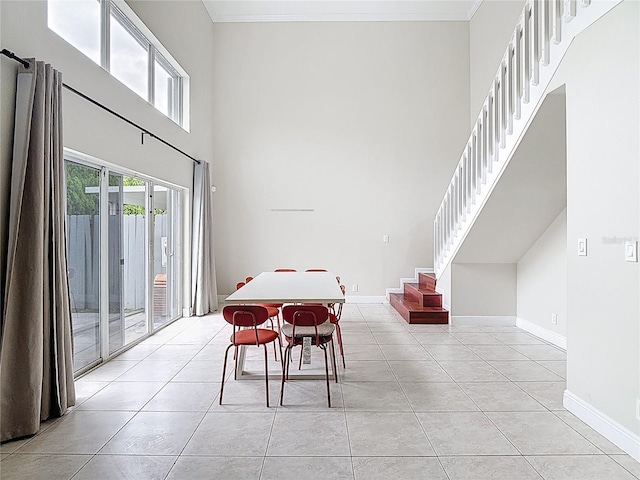 10764 Lenox Rd, Hollywood, FL 33026 - dining area with a towering ceiling, stairs, baseboards, light tile patterned flooring, and crown molding