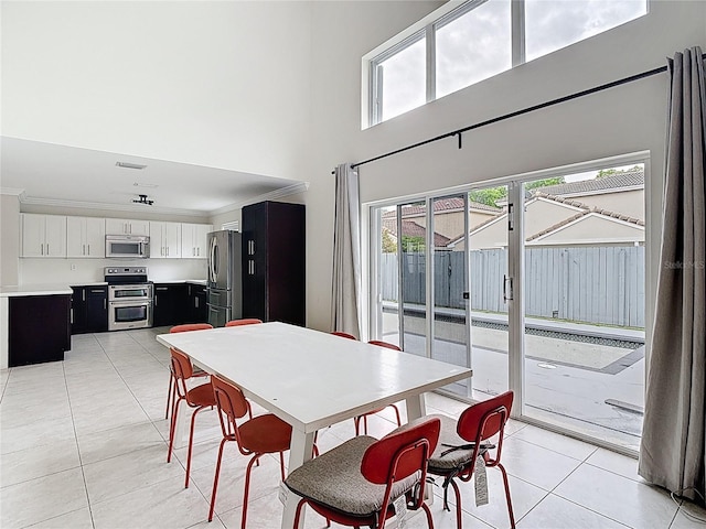 10764 Lenox Rd, Hollywood, FL 33026 - dining space featuring light tile patterned flooring and a towering ceiling