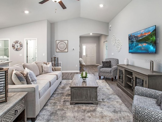 living room featuring wood finished floors, ceiling fan, arched walkways, vaulted ceiling, and recessed lighting