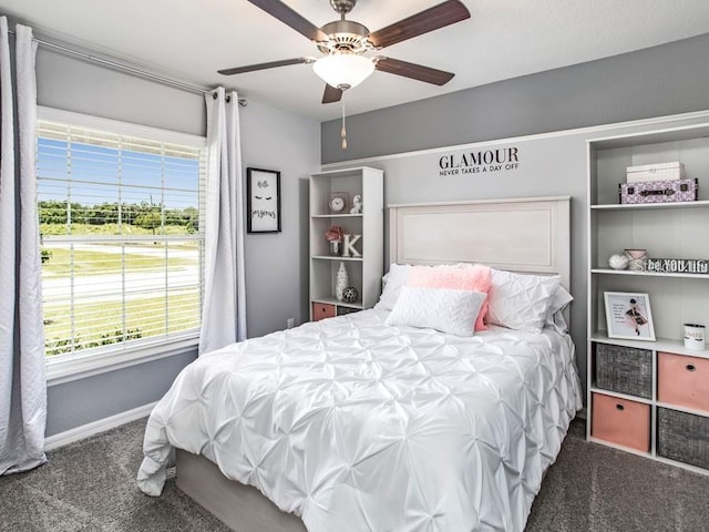 bedroom featuring carpet, baseboards, a ceiling fan, and multiple windows