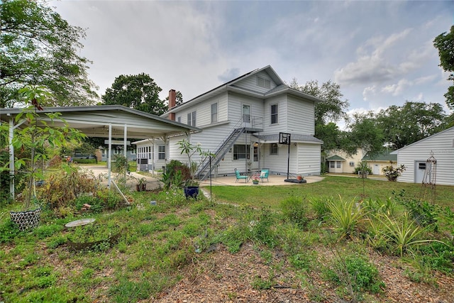 716 S Franklin Pl, Lakeland, FL 33815 - back of house featuring a patio area and a lawn
