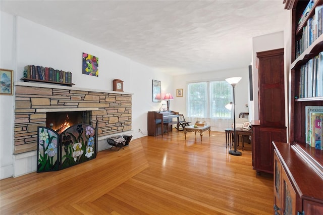 716 S Franklin Pl, Lakeland, FL 33815 - living area featuring a stone fireplace, wood finished floors, and a textured ceiling