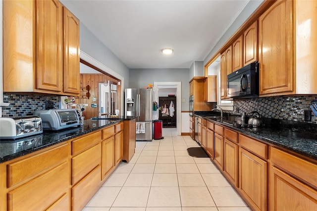 716 S Franklin Pl, Lakeland, FL 33815 - kitchen featuring black microwave, stainless steel refrigerator with ice dispenser, light tile patterned floors, and backsplash