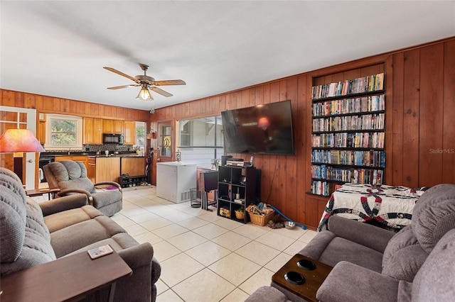 716 S Franklin Pl, Lakeland, FL 33815 - living area with wood walls, light tile patterned floors, ceiling fan, and built in features