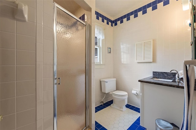716 S Franklin Pl, Lakeland, FL 33815 - bathroom with tile walls, tile patterned flooring, a shower stall, toilet, and vanity