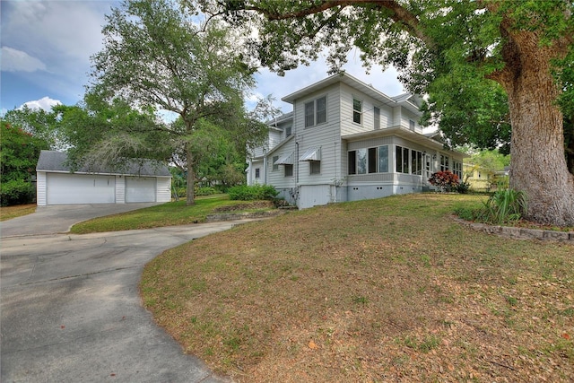 716 S Franklin Pl, Lakeland, FL 33815 - view of home's exterior with a detached garage, a lawn, and an outbuilding