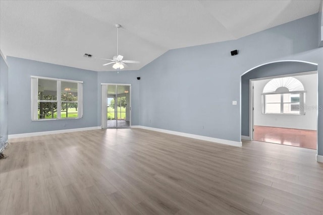 6086 Swallow Dr, Lakeland, FL 33809 - empty room with a ceiling fan, wood finished floors, plenty of natural light, and lofted ceiling