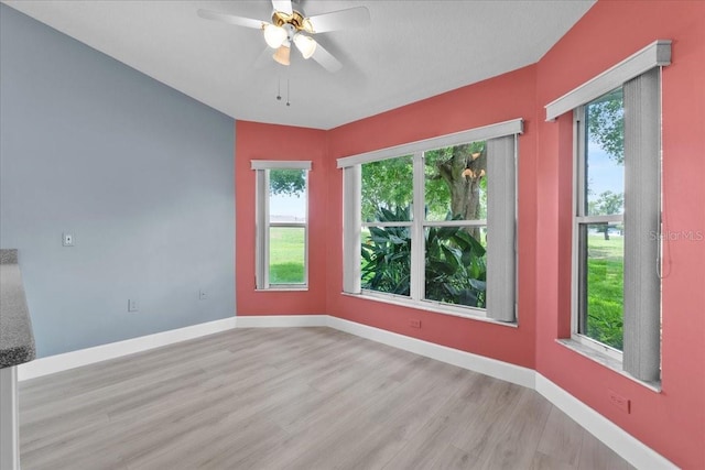 6086 Swallow Dr, Lakeland, FL 33809 - empty room with wood finished floors, ceiling fan, and baseboards