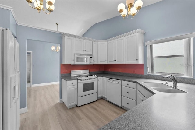 6086 Swallow Dr, Lakeland, FL 33809 - kitchen featuring a chandelier, white appliances, a sink, white cabinets, and lofted ceiling