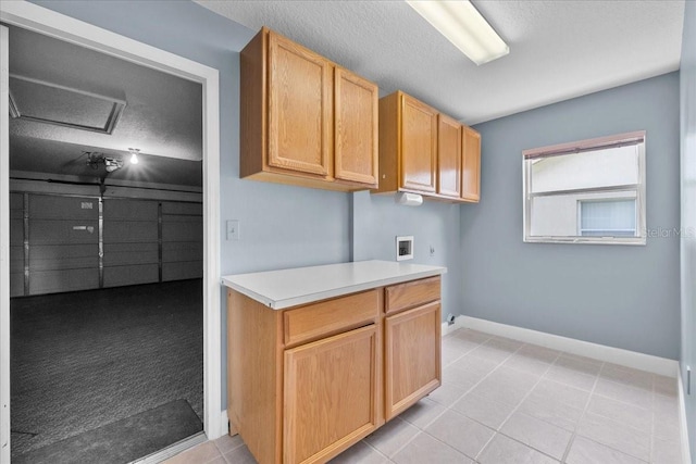 6086 Swallow Dr, Lakeland, FL 33809 - laundry area with washer hookup, baseboards, a textured ceiling, cabinet space, and light tile patterned flooring