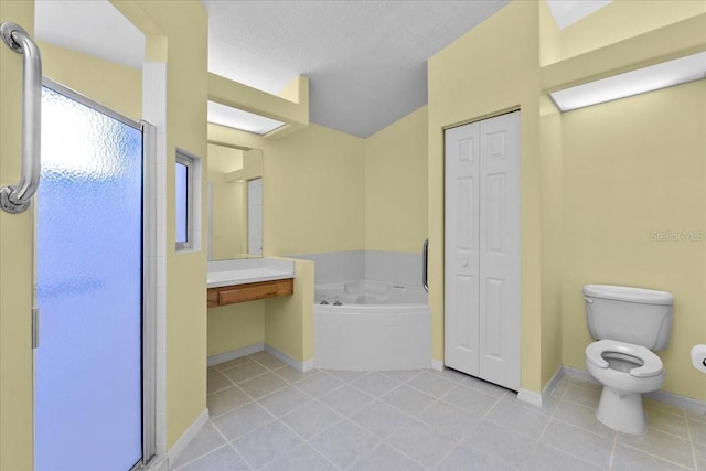 6086 Swallow Dr, Lakeland, FL 33809 - bathroom with a closet, a bath, toilet, tile patterned flooring, and a stall shower