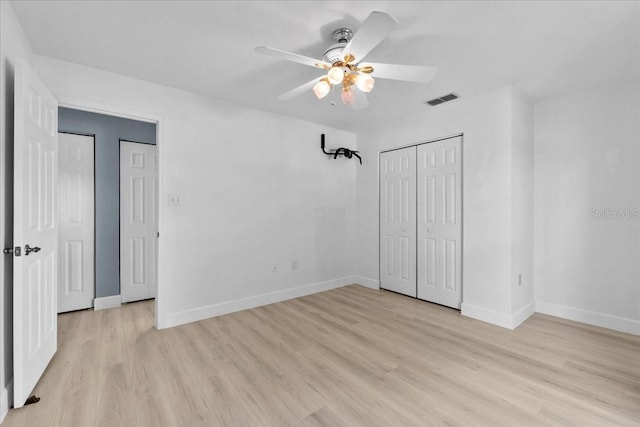 6086 Swallow Dr, Lakeland, FL 33809 - unfurnished bedroom with light wood finished floors, baseboards, a ceiling fan, and a closet