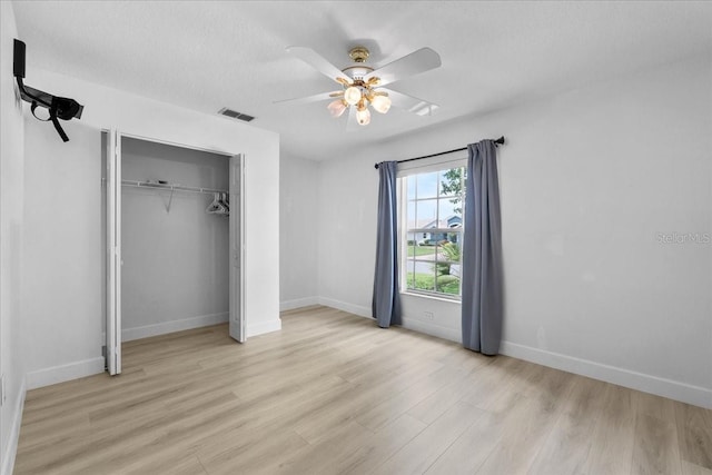 6086 Swallow Dr, Lakeland, FL 33809 - unfurnished bedroom featuring light wood-type flooring, baseboards, a closet, and ceiling fan