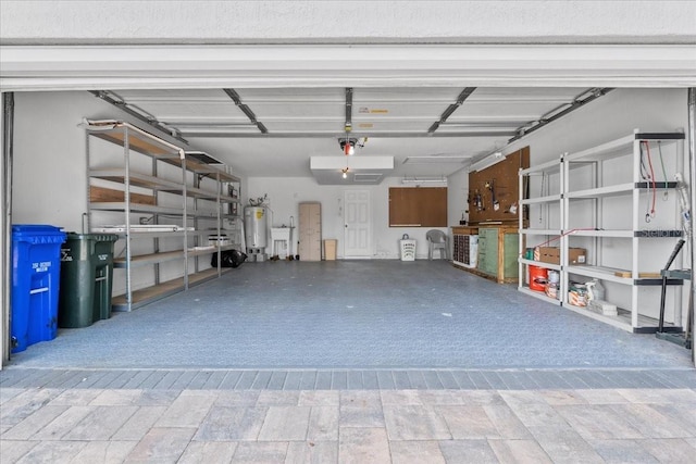 6086 Swallow Dr, Lakeland, FL 33809 - garage featuring electric water heater and a garage door opener