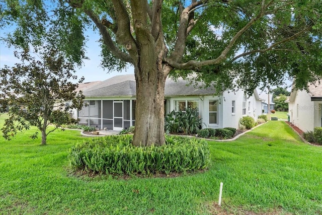 6086 Swallow Dr, Lakeland, FL 33809 - back of house featuring a yard and a sunroom