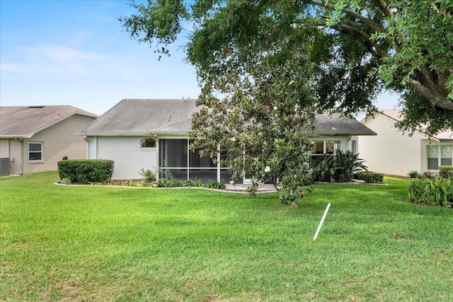 6086 Swallow Dr, Lakeland, FL 33809 - rear view of property featuring a lawn, a sunroom, central AC unit, and stucco siding