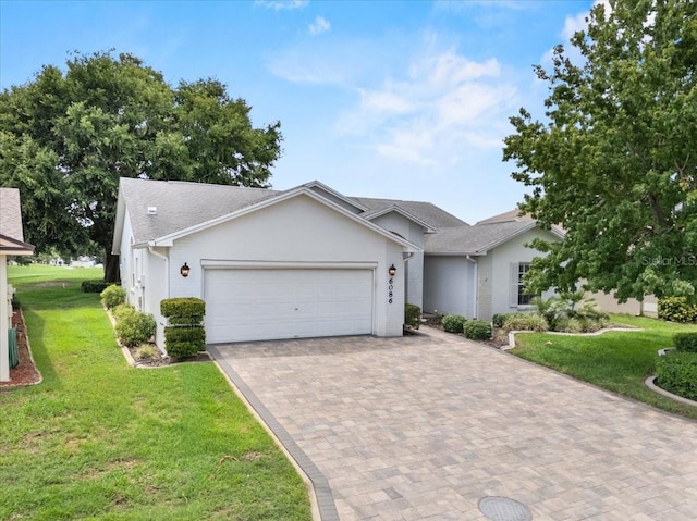 6086 Swallow Dr, Lakeland, FL 33809 - ranch-style home with a garage, a front lawn, decorative driveway, and roof with shingles