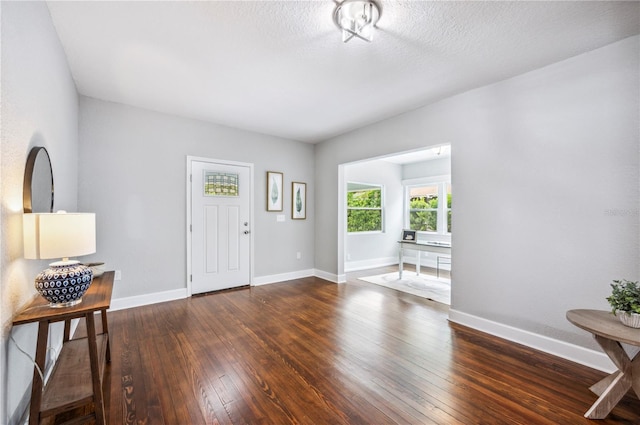 foyer featuring wood-type flooring and baseboards