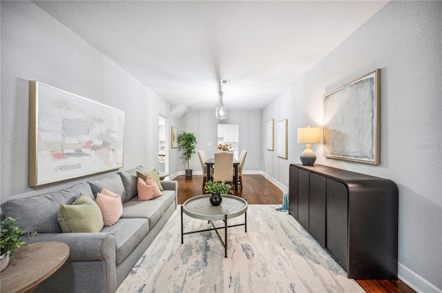 living room featuring wood finished floors and baseboards