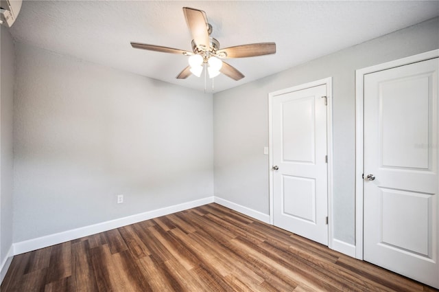 unfurnished bedroom with wood finished floors, baseboards, and ceiling fan