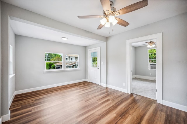 entrance foyer featuring plenty of natural light, wood finished floors, baseboards, and a ceiling fan