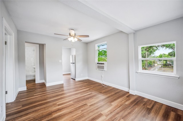 unfurnished bedroom with freestanding refrigerator, light wood-style floors, baseboards, and ceiling fan