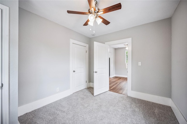 unfurnished bedroom with carpet flooring, baseboards, and a ceiling fan